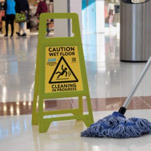 Safeguard-R yellow safety sign with blue SYRtex mop mopping in shop